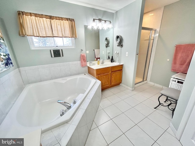 bathroom featuring tile patterned floors, vanity, and shower with separate bathtub