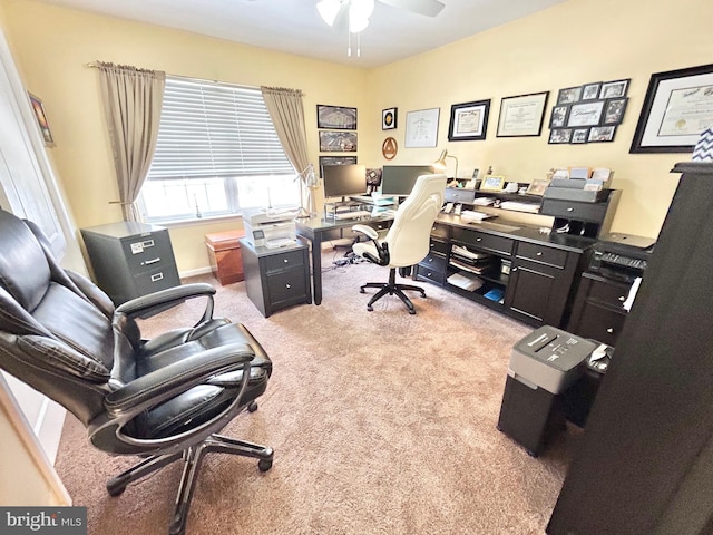 office area with ceiling fan and light carpet