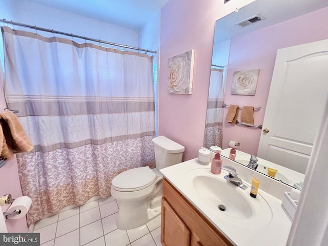 bathroom featuring tile patterned flooring, vanity, and toilet