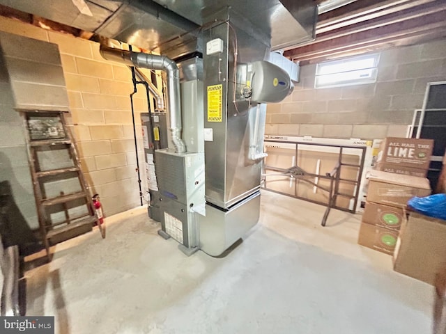 utility room with heating unit and water heater