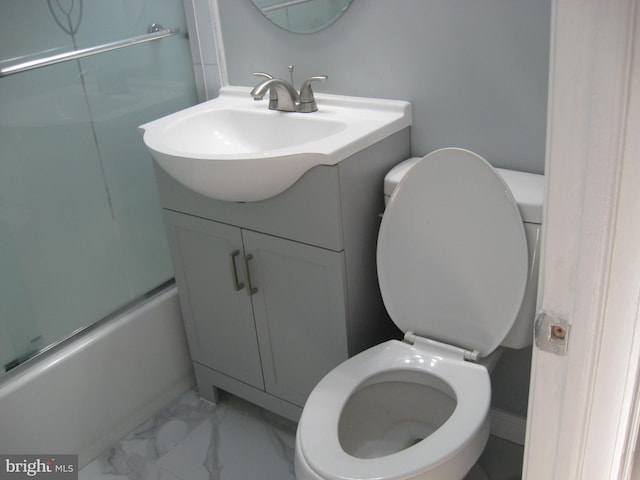 full bathroom featuring vanity, toilet, and bath / shower combo with glass door