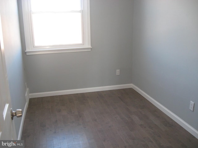 spare room featuring dark hardwood / wood-style flooring