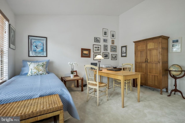 carpeted bedroom with vaulted ceiling