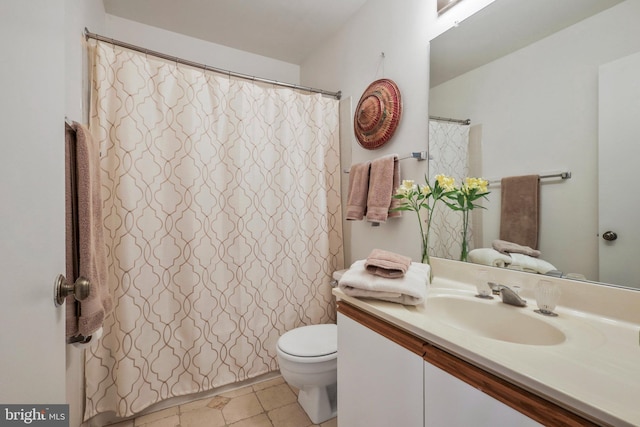 bathroom with tile patterned floors, vanity, and toilet