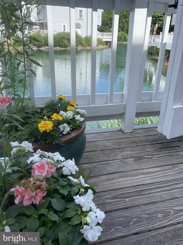 unfurnished sunroom featuring a water view and a healthy amount of sunlight