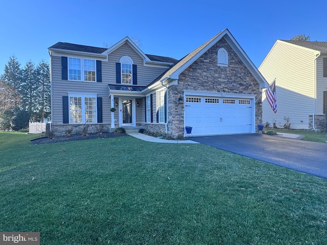 view of front of property with a garage and a front lawn