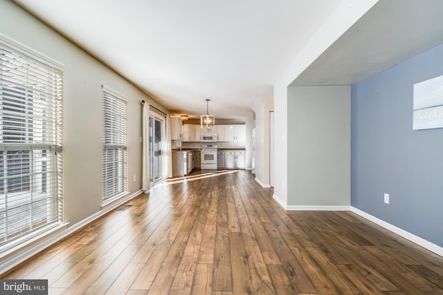 unfurnished living room featuring dark hardwood / wood-style floors