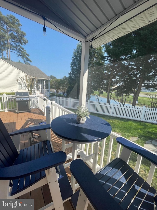 wooden terrace featuring a lawn and area for grilling