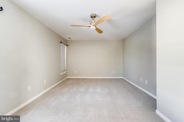 carpeted spare room with ceiling fan