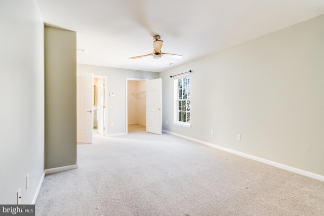 unfurnished room featuring light colored carpet and ceiling fan