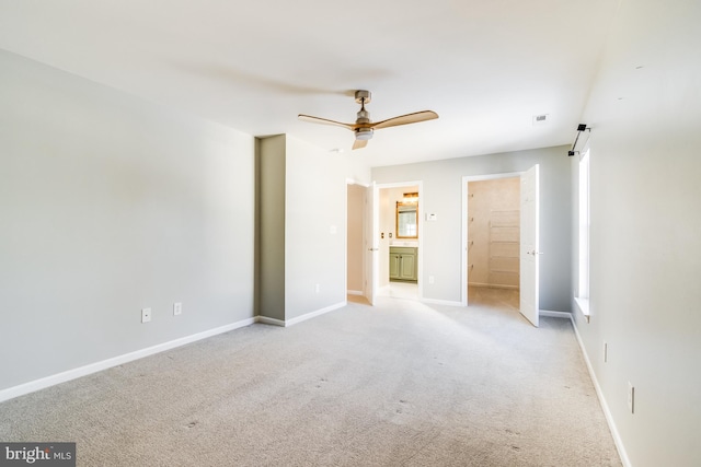 unfurnished room featuring ceiling fan and light colored carpet