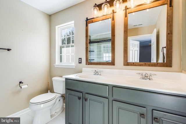 bathroom featuring vanity, tile patterned flooring, and toilet