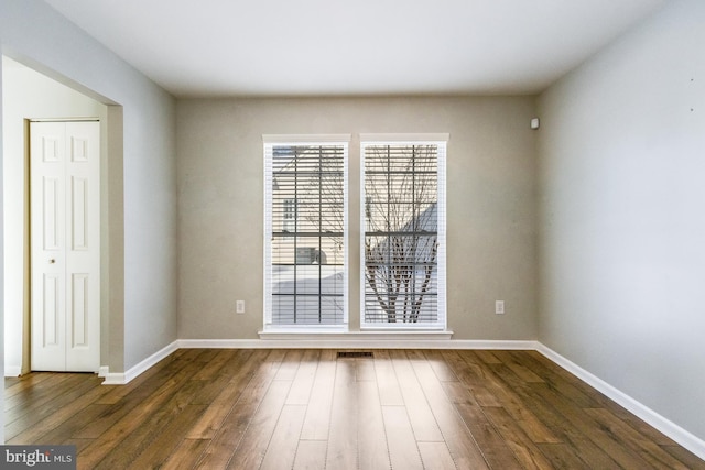 spare room featuring dark hardwood / wood-style floors