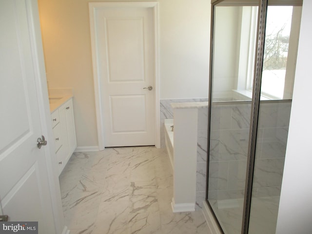 bathroom featuring vanity and shower with separate bathtub