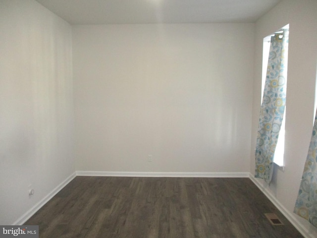 spare room with dark hardwood / wood-style flooring