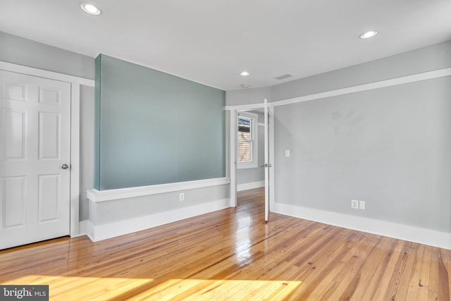 unfurnished room with hardwood / wood-style floors