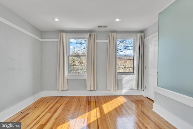 unfurnished room with hardwood / wood-style floors