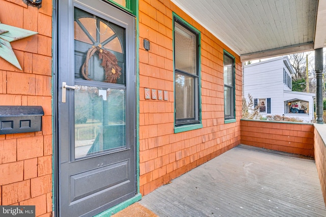 view of exterior entry featuring a porch