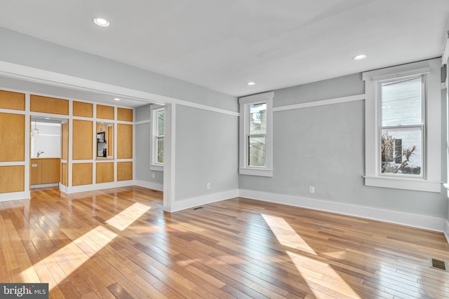 empty room with sink and light hardwood / wood-style flooring