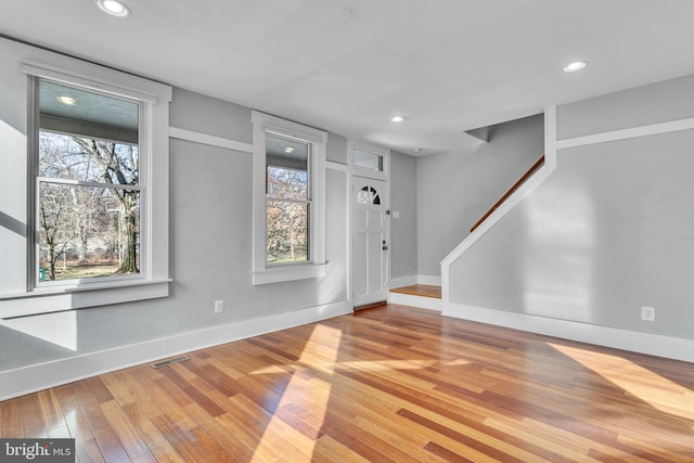 interior space with a wealth of natural light and light hardwood / wood-style flooring