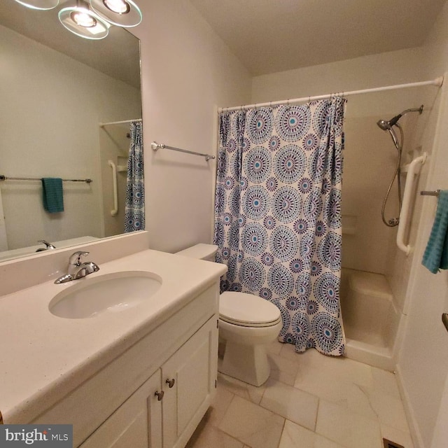 bathroom with tile patterned floors, curtained shower, vanity, and toilet