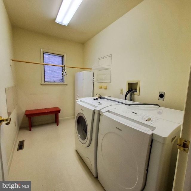 laundry room with washing machine and clothes dryer