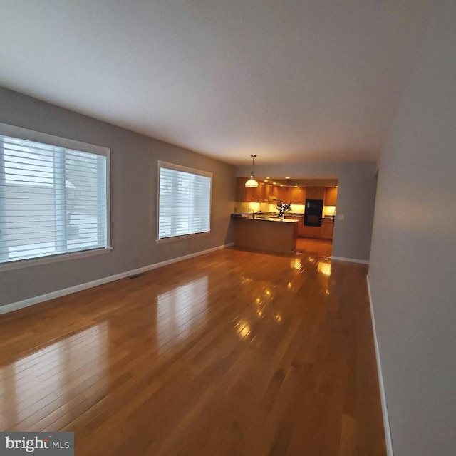 unfurnished living room featuring dark wood-type flooring