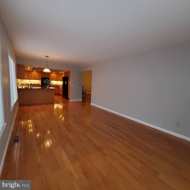 unfurnished living room with dark hardwood / wood-style flooring