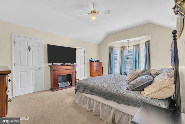 bedroom with light colored carpet, vaulted ceiling, and ceiling fan