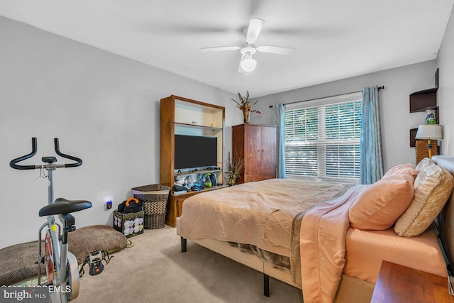 bedroom featuring light carpet and ceiling fan