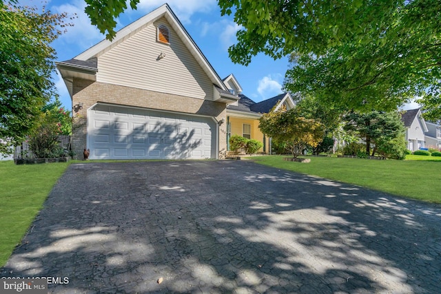 view of front of home featuring a garage and a front lawn