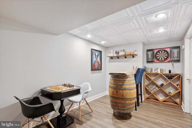 bar with light hardwood / wood-style floors