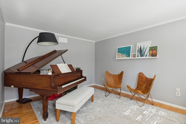 miscellaneous room featuring wood-type flooring and crown molding