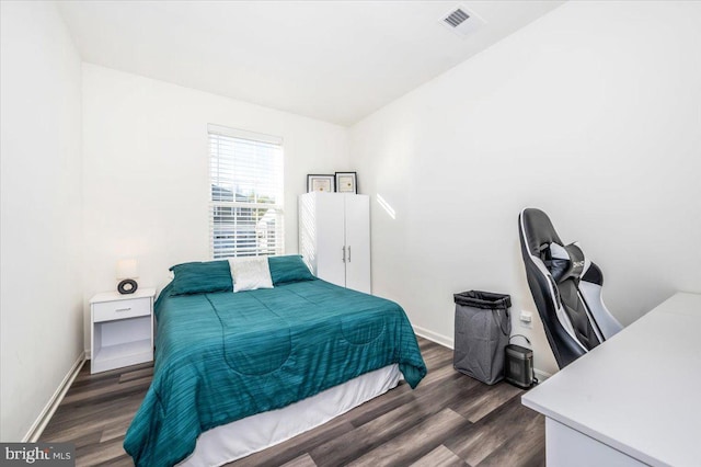 bedroom featuring dark hardwood / wood-style floors and lofted ceiling