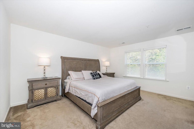 bedroom with light colored carpet