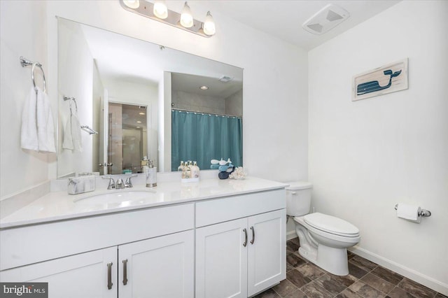 bathroom with a shower with curtain, vanity, and toilet