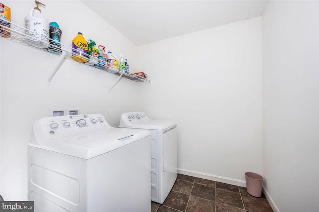 clothes washing area with washing machine and dryer