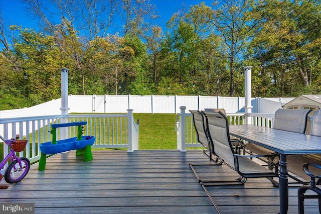 wooden terrace with a lawn