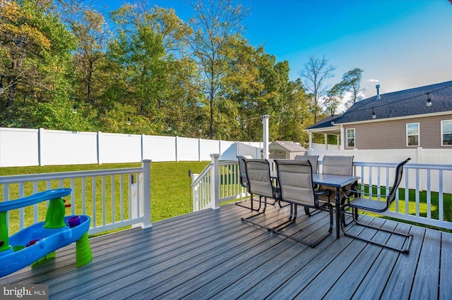 wooden terrace featuring a yard