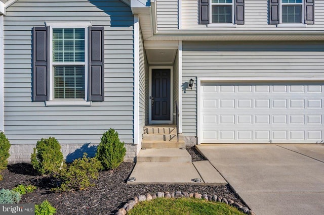 doorway to property with a garage