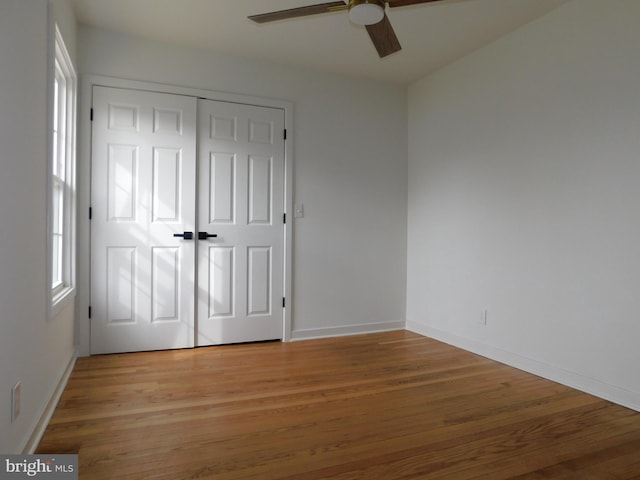 unfurnished bedroom with a closet, ceiling fan, and light hardwood / wood-style flooring