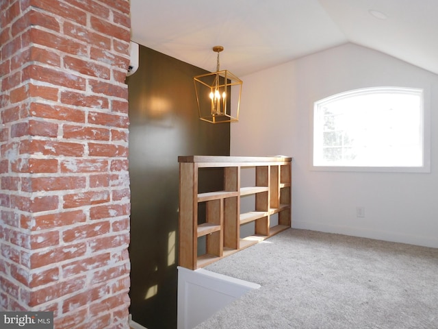 carpeted spare room featuring lofted ceiling and a chandelier