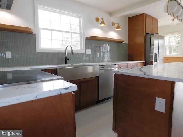 kitchen featuring plenty of natural light, stainless steel appliances, and backsplash