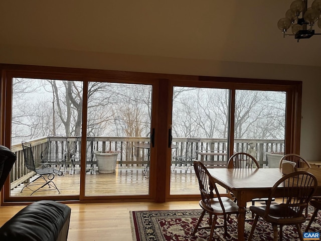 sunroom / solarium with a wealth of natural light and an inviting chandelier