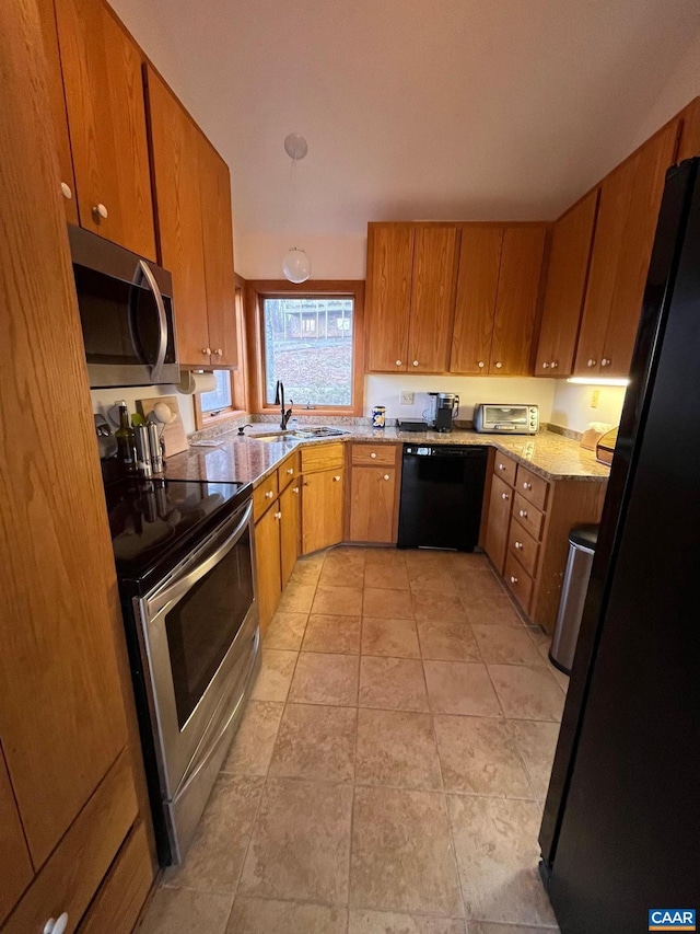 kitchen featuring light stone countertops, light tile patterned floors, sink, and black appliances