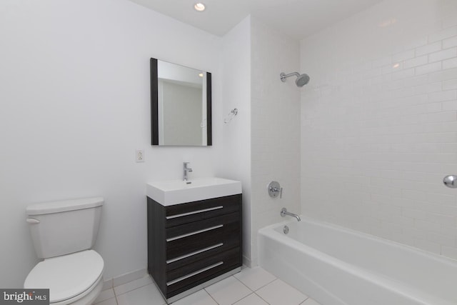 full bathroom featuring tile patterned floors, vanity, tiled shower / bath combo, and toilet