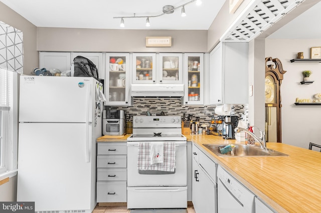 kitchen with decorative backsplash, white appliances, white cabinetry, and sink