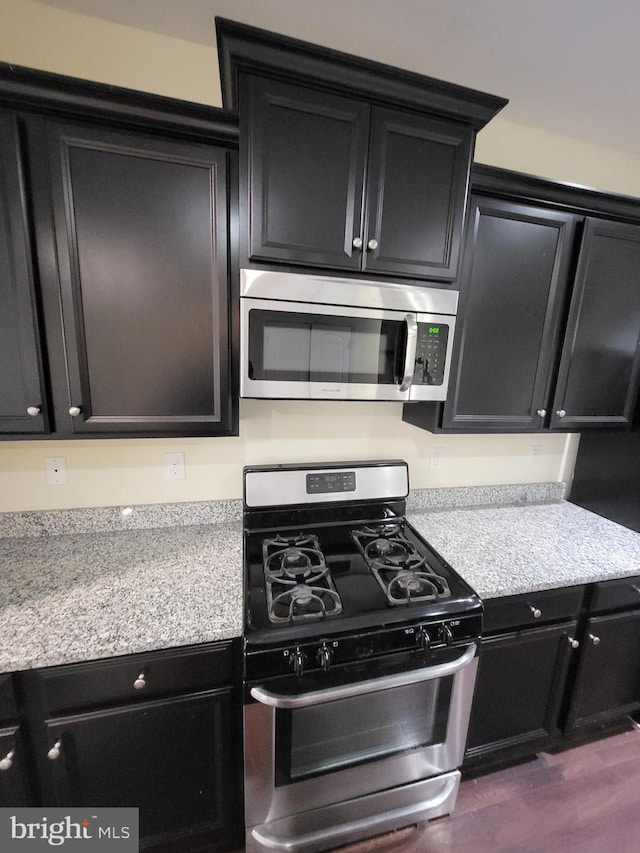 kitchen with dark hardwood / wood-style flooring and stainless steel appliances