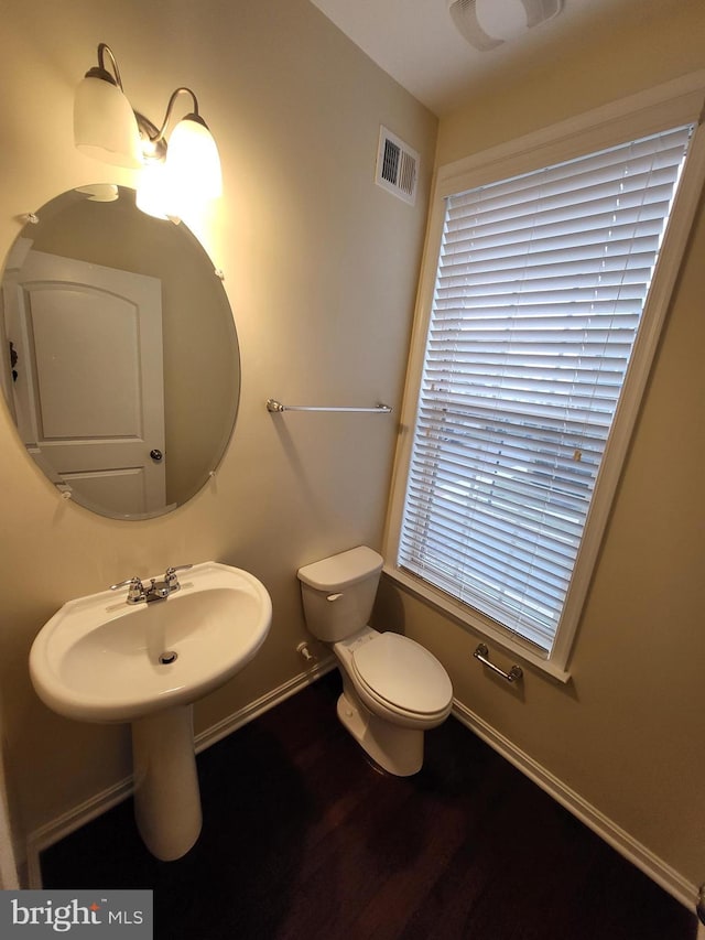 bathroom with wood-type flooring and toilet