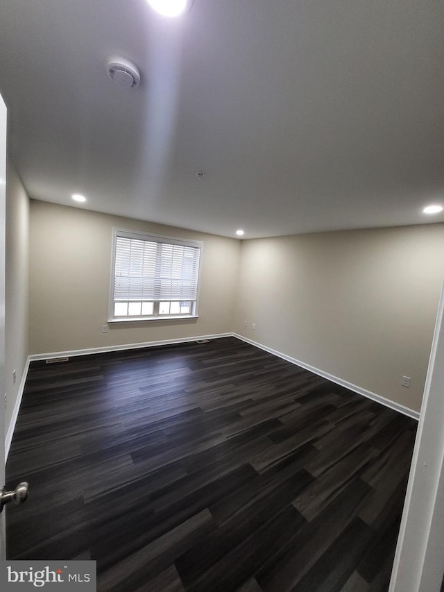 empty room with dark hardwood / wood-style floors